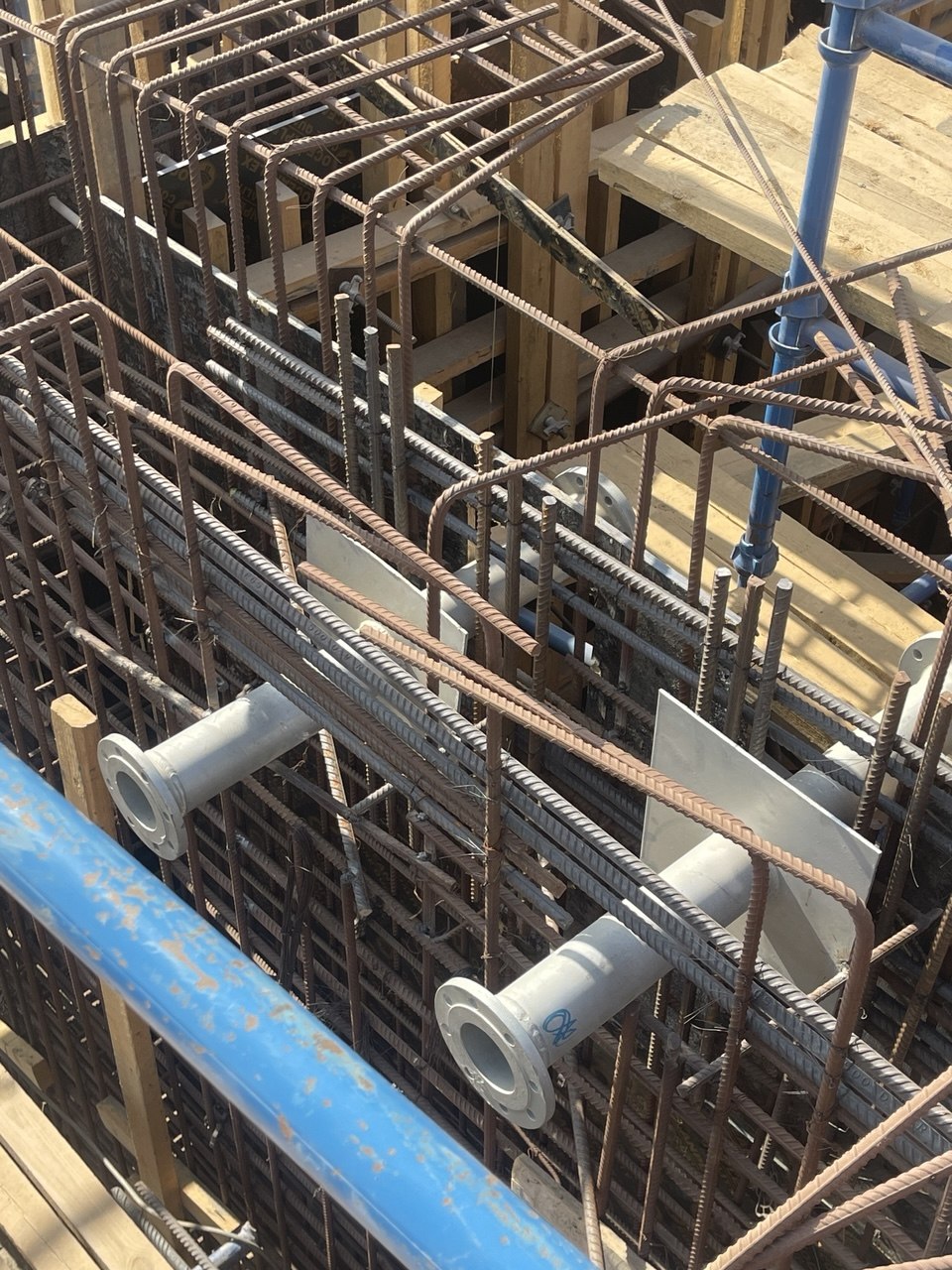 Pipe penetration sleeves coordinated within rebar cage on site